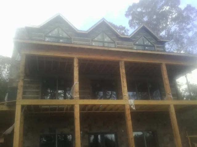 Dormers and porch framing on a large log home under construction in East Hickory